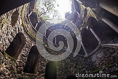 The Initiation well of Quinta da Regaleira in Sintra. The depth of the well is 27 meters. It connects with other tunnels through u Editorial Stock Photo