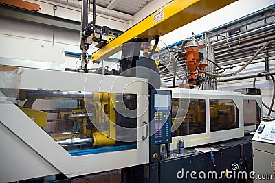 Injection molding machines in a large factory Stock Photo