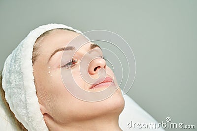 Injection at spa salon. Doctor paint on skin. Closeup. Pretty female patient Stock Photo