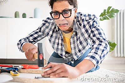 Injured black woman during home renovation work, focus on face Stock Photo