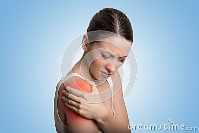 Injured joint. Woman patient in pain having painful shoulder colored in red. Stock Photo