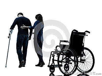 Injured man with crutches with woman walking away from whee Stock Photo