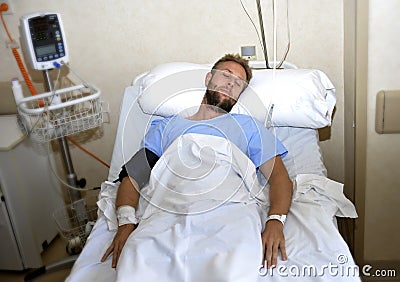 Injured man lying in bed hospital room resting from pain looking in bad health condition Stock Photo