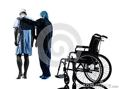 Injured man walking away from wheelchair with nurse silhouette Stock Photo