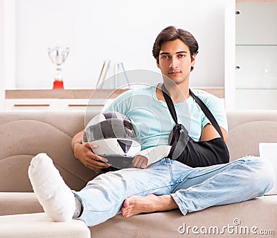 Injured motorbike rider recovering at home Stock Photo