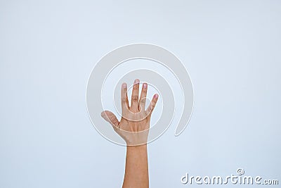 Injured painful finger with white bandage. Hand has been injured by the accident and showing thumb up.The thumb is wrapped with a Stock Photo