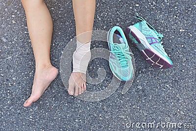 Injured runner sitting on the road Stock Photo