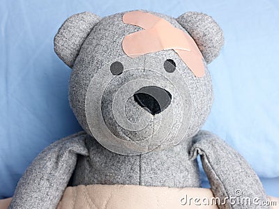 Injured Teddy Bear plasters head bed Stock Photo