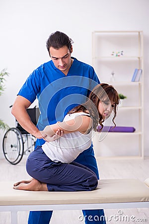 Injured woman visiting young male doctor osteopath Stock Photo