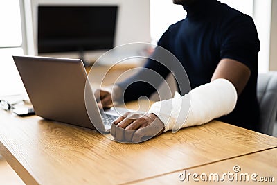 Injured Worker Compensation. Broken Arm African Man Stock Photo