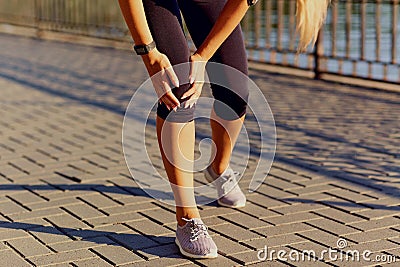 Injury of a knee on a run in a runner. Stock Photo