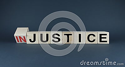 Injustice or justice. Cubes form the choice words Injustice or Justice Stock Photo