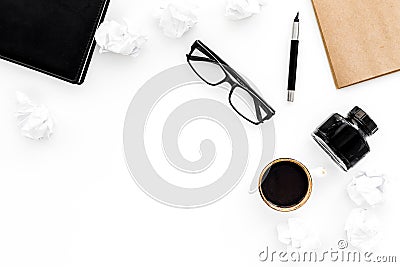 Ink, dip pen, notebook, coffee, glasses for writer workplace set on white office background top view mock-up Stock Photo