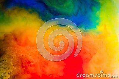 Ink in the water. A splash of red, blue, yellow and green paint. Abstract background Stock Photo