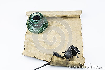 An inkwell and a black rose of metal lie on a blank sheet of paper, isolated on a white background. Space for text Stock Photo