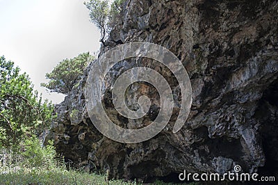The inland end of a cavernous cliff. Rockface. Stock Photo