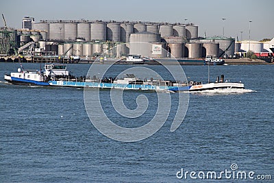 Inland tanker ship Colonia in the botlek port at chemical industries in the Botlek Harbor in Rotterdam with Vopak tanks Editorial Stock Photo