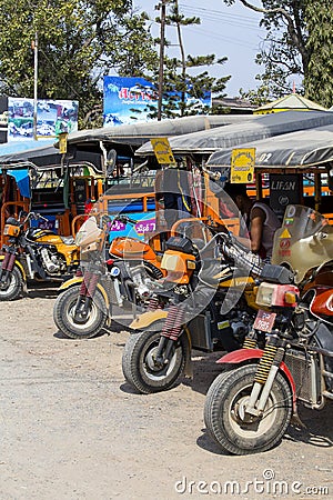 Auto rickshaw, three wheels motorcycle taxi on the street in Myanmar. This transport is cheap and popular in Burma. Editorial Stock Photo