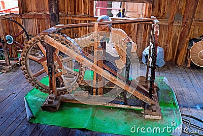 INLE LAKE, MYANMAR - NOVEMBER 22, 2015: Man behind an old fashioned loom in Burma Asia Editorial Stock Photo