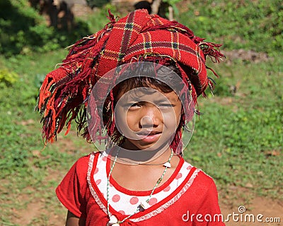 Inle Lake, Myanmar - October 2015: Young Burmese girl with head wrap trying to sell her goods to the tourists Editorial Stock Photo