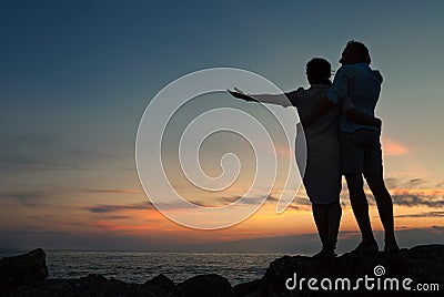Inlove couple on the seacoast at sunset time Stock Photo