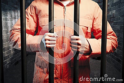 Inmate inside dark prison cell at night Stock Photo