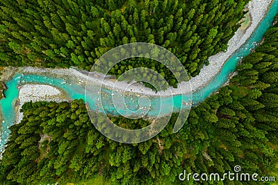 Inn River flowing in the forest in Switzerland. Aerial view from drone on a blue river in the mountains Stock Photo