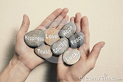 Inner balance concept: hands holding stones with the words happi Stock Photo