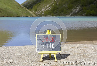 Inner child symbol. Concept words Inner child on beautiful black chalk blackboard. Beautiful mountain lake background. Stock Photo