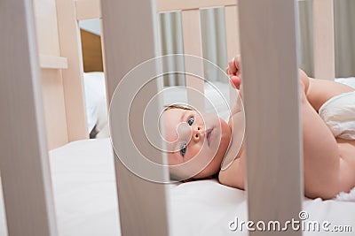 Innocent baby boy lying in crib Stock Photo