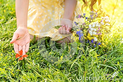 Innocent little kid touching butterfly on meadow Stock Photo