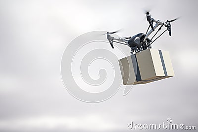 Innovative fast delivery service with modern grey quadrocopter carrying cardboard box in the air at gloomy background. Stock Photo