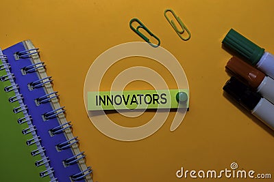 Innovators write on sticky notes. Isolated on orange table background Stock Photo