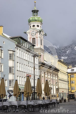 View of Maria Teresa Street with tower of Hospital Church of the Holy Spirit, Innsbruck, Austria Editorial Stock Photo