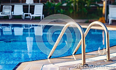 Inox handrail entrance in Pool pure clean water Stock Photo