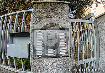 Input iron gate and pillar on which the Intercom. Stock Photo