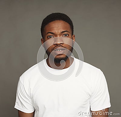 Inquiry facial expression, black man Stock Photo