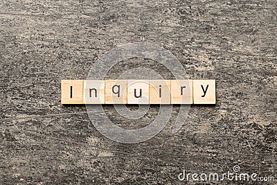 inquiry word written on wood block. inquiry text on table, concept Stock Photo