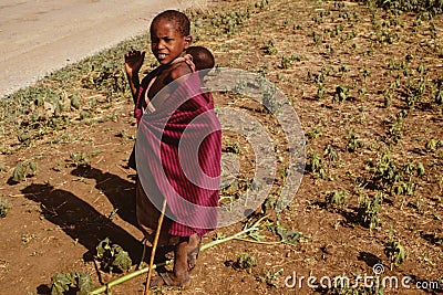 Inquisitive Maasai children in the Serengeti Park Editorial Stock Photo