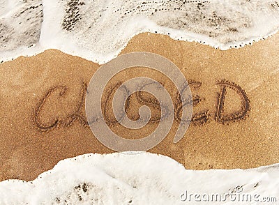 Inscription CLOSE on the yellow sand. Stock Photo