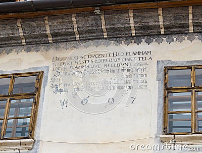 The inscription on a decorative decorated wall dated 1697 in the castle of old city. Sighisoara city in Romania Editorial Stock Photo