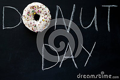 inscription donut day on a chalk board and sweet glaze donut Stock Photo