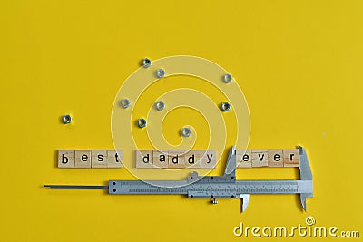 Inscription Fathers Day with different tools on yellow background. Wooden letter BEST DADDY EVER and calipers Stock Photo