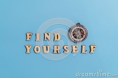 Inscription find yourself and compass on a blue background. concept of asserting oneself in life and finding your destiny. Stock Photo