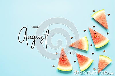 Inscription Hello August. Fresh red watermelon slice Isolated light blue background. Top view, Flat lay. Stock Photo