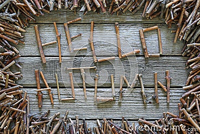 The inscription Hello autumn with wooden sticks on wooden background. Stock Photo