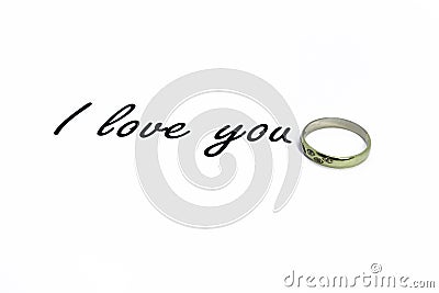 Inscription I love you on a white background. Behind the text a gold ring with stones. Stock Photo