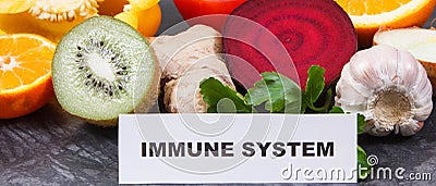 Inscription immune system with ripe fruits and vegetables. Source vitamins, minerals and dietary fiber Stock Photo