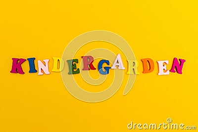 The inscription `Kindergarten` in colorful letters on a yellow background Stock Photo