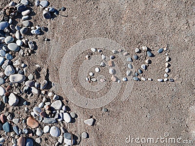 Inscription lined with stones in the sand 2021 Stock Photo